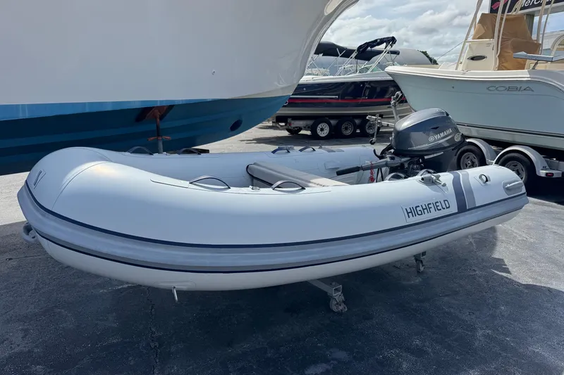 Slide: The Image of 2023 Highfield Ultralite 310 inflatable boat with Yamaha outboard motor on display. - 2