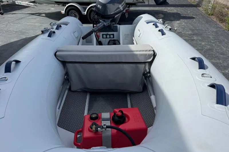 Slide: The Image of 2023 Highfield Ultralite 310 inflatable boat with outboard motor and red fuel tank. - 5