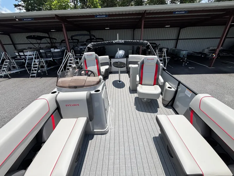 Slide: The Image of The image shows a 2026 Sylvan MIRAGE X1 DH pontoon boat with gray and red seating. - 4