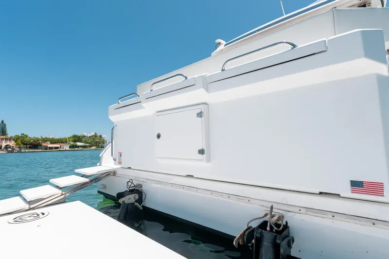 Slide: The Image of 2022 Cruisers Yachts 42 Cantius, rear view with swim platform and American flag. - 12