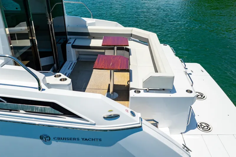 Slide: The Image of 2022 Cruisers Yachts 42 Cantius with elegant seating and tables on deck. - 15