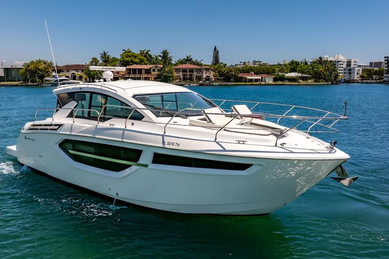 Slide: The Image of 2022 Cruisers Yachts 42 Cantius on serene blue water, showcasing sleek design and luxury. - 17
