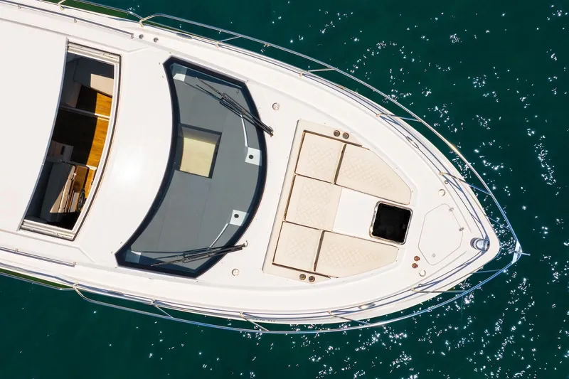 Slide: The Image of Top view of 2022 Cruisers Yachts 42 Cantius on sparkling water. - 19