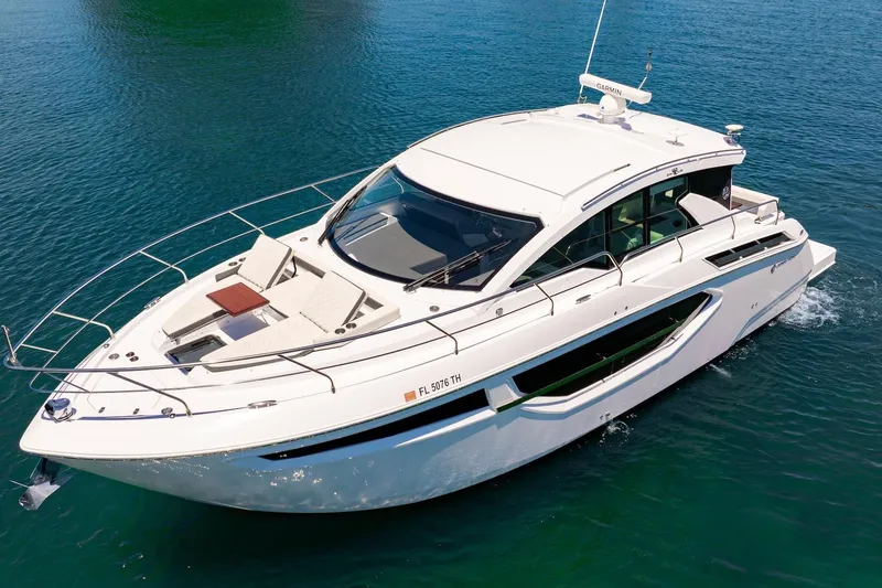 Slide: The Image of 2022 Cruisers Yachts 42 Cantius cruising on clear blue water. - 2