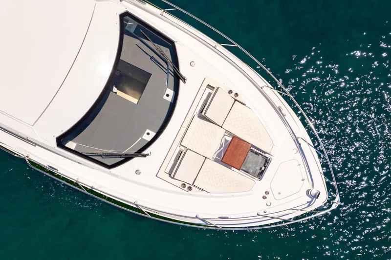 Slide: The Image of Aerial view of 2022 Cruisers Yachts 42 Cantius on sparkling blue water. - 29