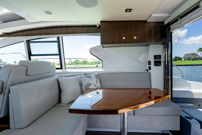 Slide: The Image of Luxurious interior of 2022 Cruisers Yachts 42 Cantius with elegant seating and wooden table. - 34