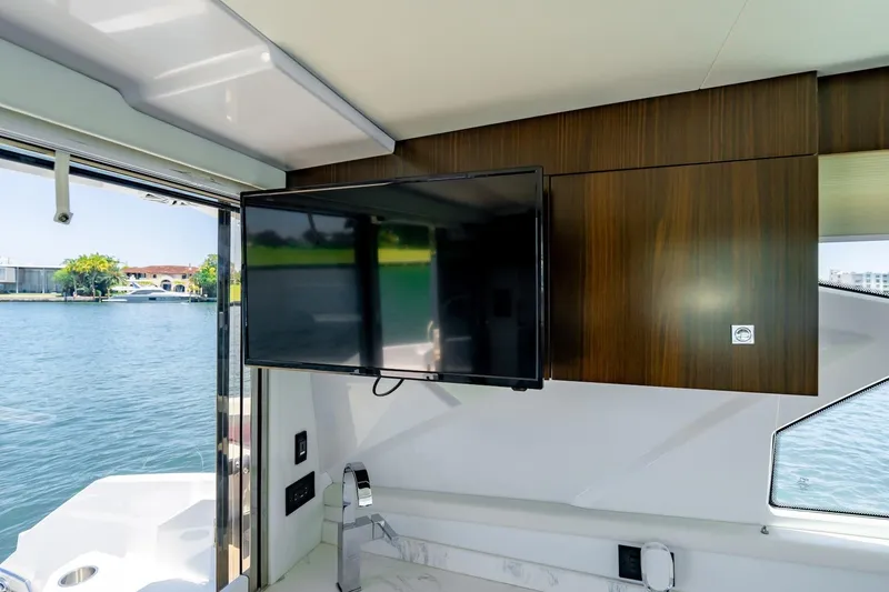 Slide: The Image of Interior of 2022 Cruisers Yachts 42 Cantius with mounted TV and water view. - 35