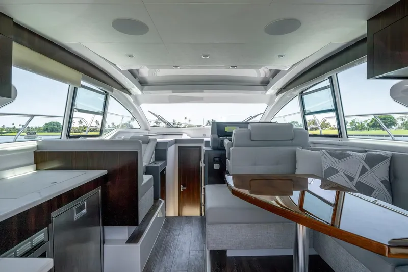 Slide: The Image of Interior of 2022 Cruisers Yachts 42 Cantius, featuring modern seating and panoramic windows. - 36
