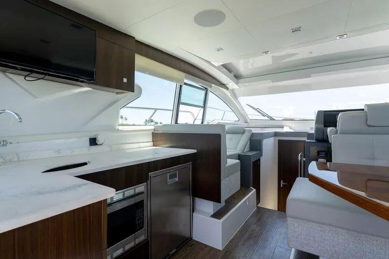 Slide: The Image of Luxurious interior of 2022 Cruisers Yachts 42 Cantius with modern kitchen and seating area. - 38
