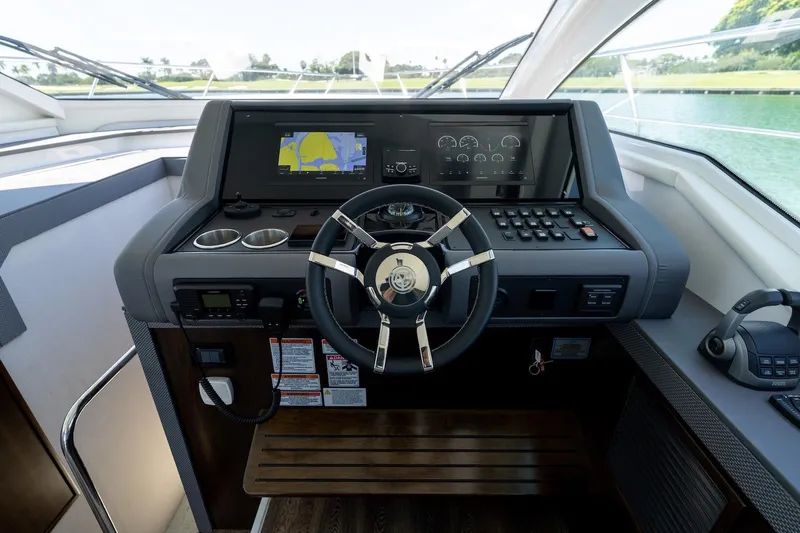 Slide: The Image of Helm of 2022 Cruisers Yachts 42 Cantius with navigation screens and controls. - 40