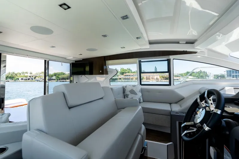 Slide: The Image of Luxurious interior of 2022 Cruisers Yachts 42 Cantius with waterfront view. - 42