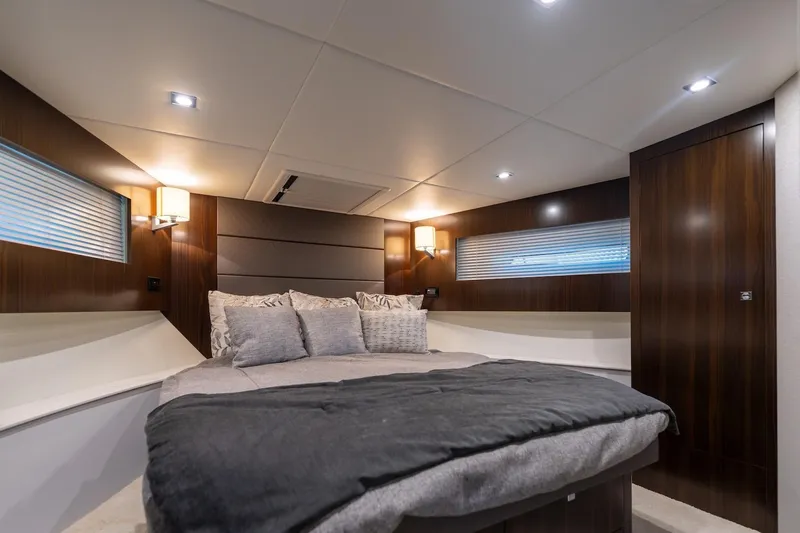 Slide: The Image of Luxurious bedroom interior of 2022 Cruisers Yachts 42 Cantius with modern lighting and wood accents. - 45