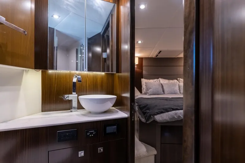 Slide: The Image of Luxurious interior of 2022 Cruisers Yachts 42 Cantius, featuring elegant bathroom and cozy bedroom. - 46