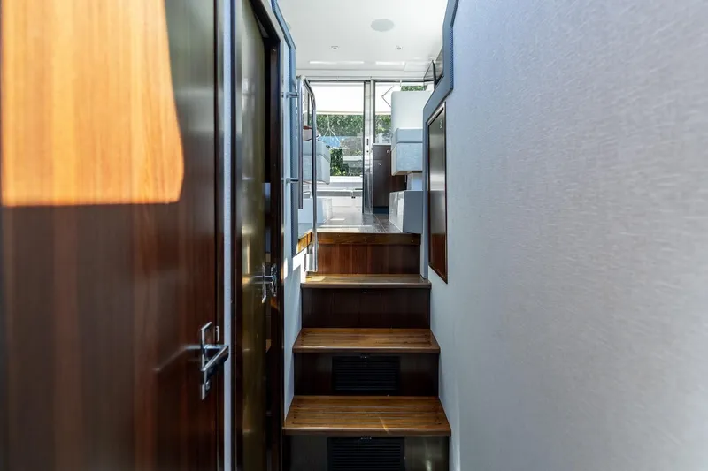 Slide: The Image of Interior hallway of 2022 Cruisers Yachts 42 Cantius with wooden steps and modern design. - 48