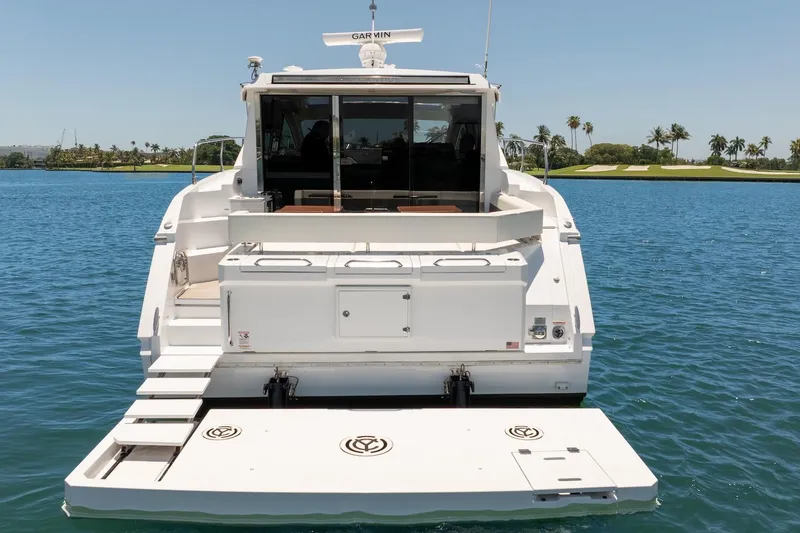 Slide: The Image of 2022 Cruisers Yachts 42 Cantius on water, rear view with swim platform. - 5