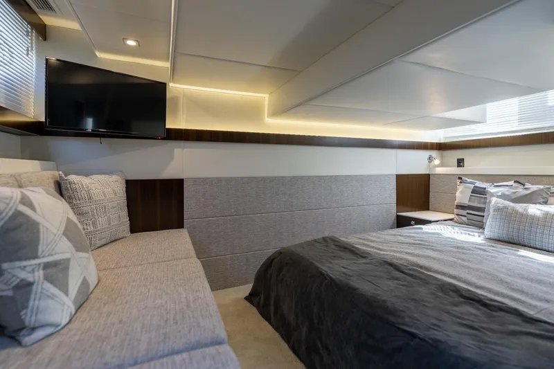 Slide: The Image of Luxurious interior of 2022 Cruisers Yachts 42 Cantius with modern bedding and TV. - 50