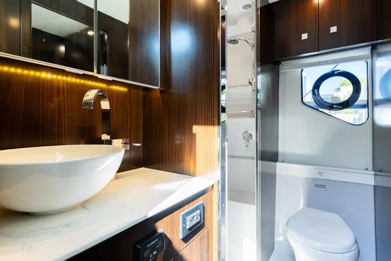 Slide: The Image of Luxurious bathroom interior of 2022 Cruisers Yachts 42 Cantius with modern fixtures and wood accents. - 55