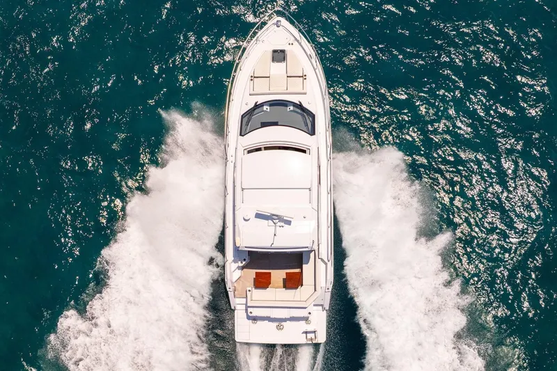Slide: The Image of Aerial view of 2022 Cruisers Yachts 42 Cantius cruising on blue ocean waters. - 56