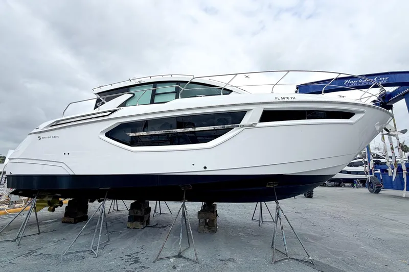 Slide: The Image of 2022 Cruisers Yachts 42 Cantius on stands, sleek design, overcast sky. - 59