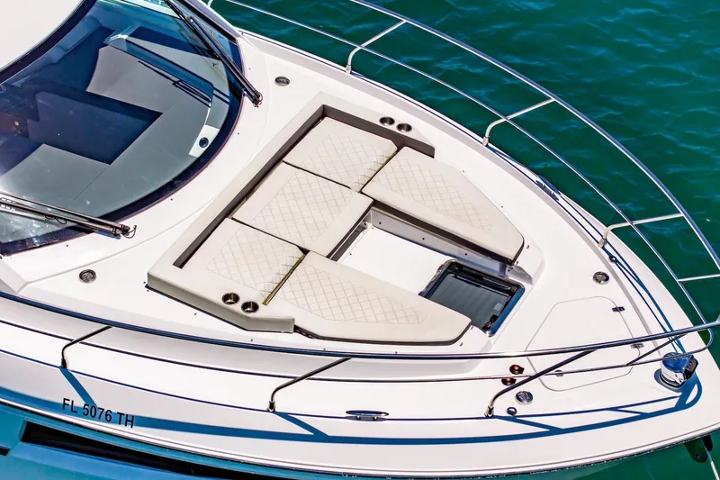 Slide: The Image of 2022 Cruisers Yachts 42 Cantius with sunbathing deck on turquoise water. - 6