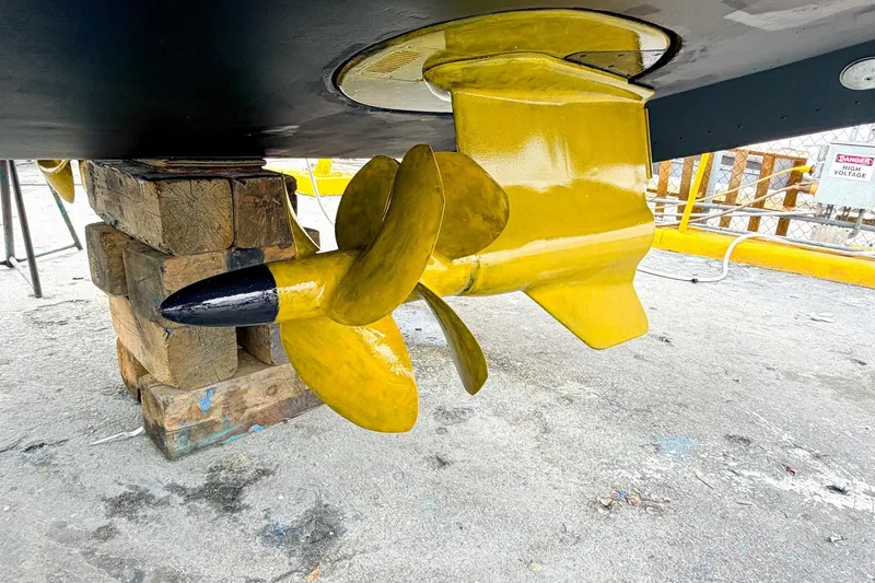 Slide: The Image of Yellow propeller of 2022 Cruisers Yachts 42 Cantius on wooden blocks. - 64