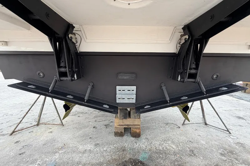 Slide: The Image of Rear view of 2022 Cruisers Yachts 42 Cantius, showcasing trim tabs and hull details. - 68