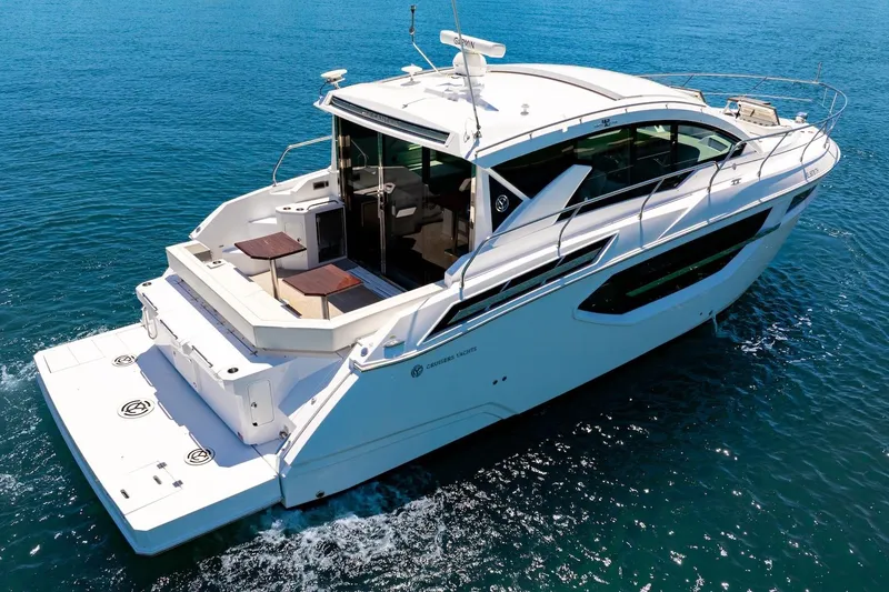 Slide: The Image of 2022 Cruisers Yachts 42 Cantius on open water, showcasing sleek design and luxury features. - 9