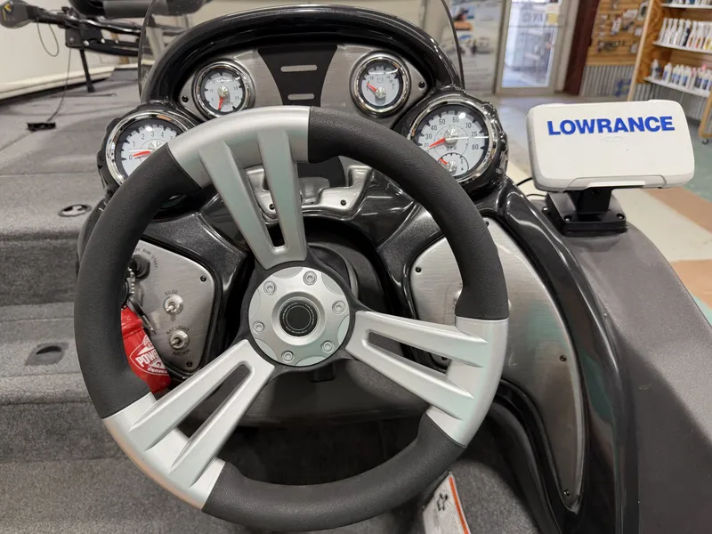 Slide: The Image of Steering wheel and dashboard of a Tracker Pro Team 195 TXW boat. - 5
