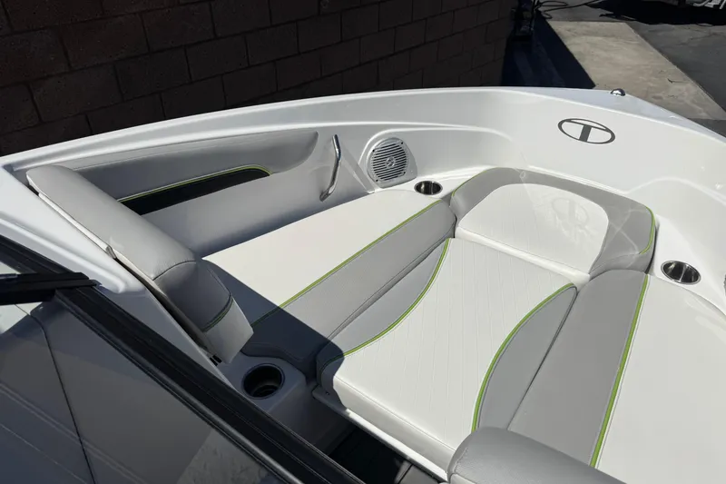 Slide: The Image of 2022 Tahoe 210 Si Limited boat interior with white and gray seating, green accents. - 11