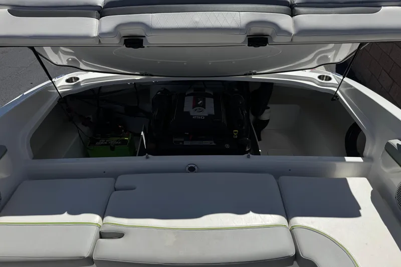 Slide: The Image of 2022 Tahoe 210 Si Limited boat engine compartment with open hatch and visible seating. - 17