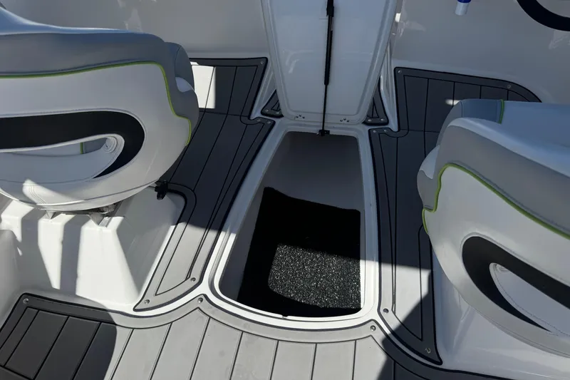 Slide: The Image of 2022 Tahoe 210 Si Limited boat interior with seating and storage compartment. - 21