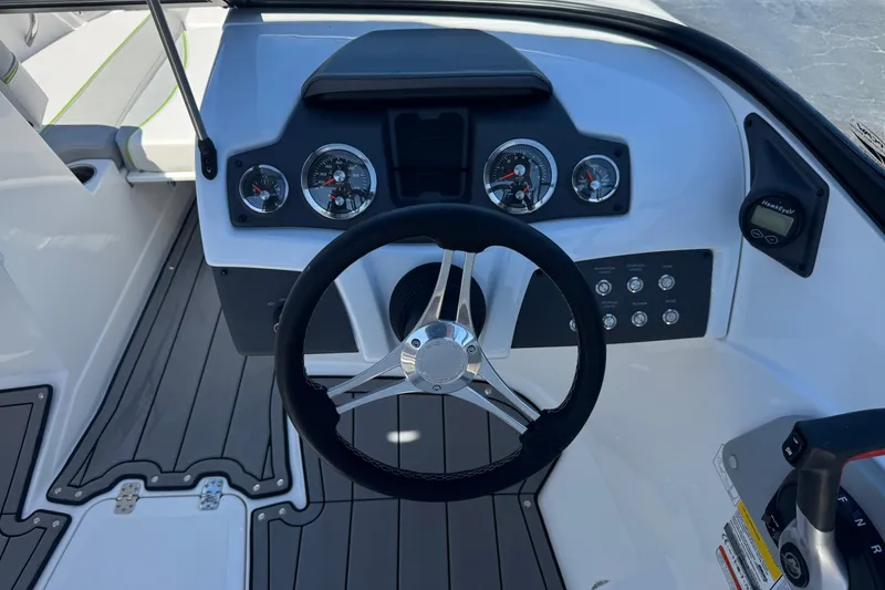 Slide: The Image of 2022 Tahoe 210 Si Limited boat dashboard with steering wheel and gauges. - 26