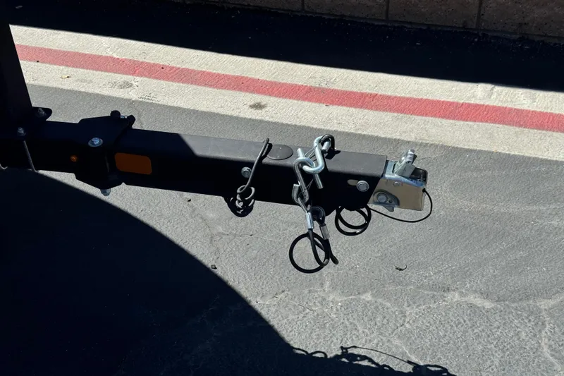 Slide: The Image of Trailer hitch of a 2022 Tahoe 210 Si Limited on asphalt pavement. - 28