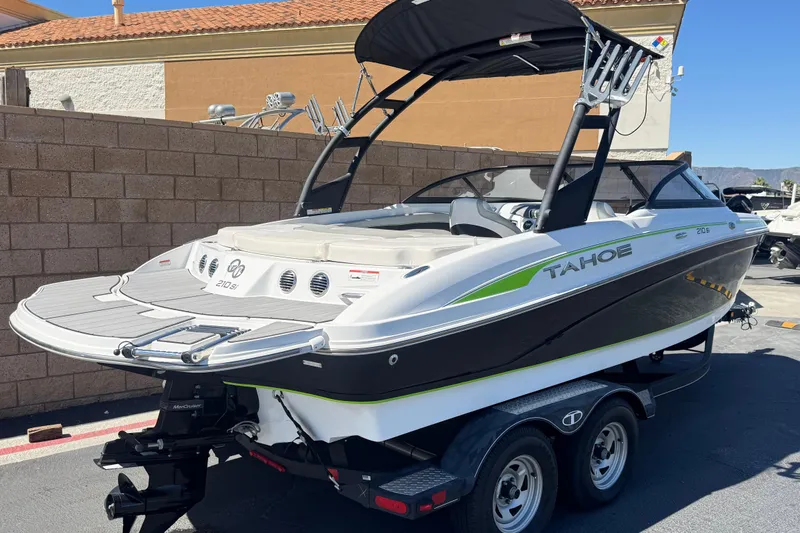 Slide: The Image of 2022 Tahoe 210 Si Limited boat on trailer, parked outdoors. - 5