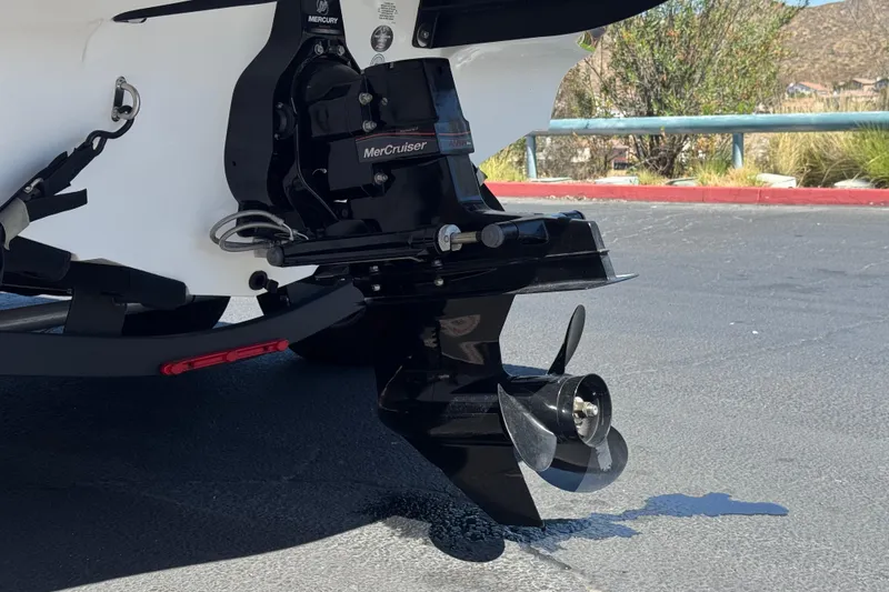 Slide: The Image of 2022 Tahoe 210 Si Limited boat with MerCruiser engine and propeller on pavement. - 7