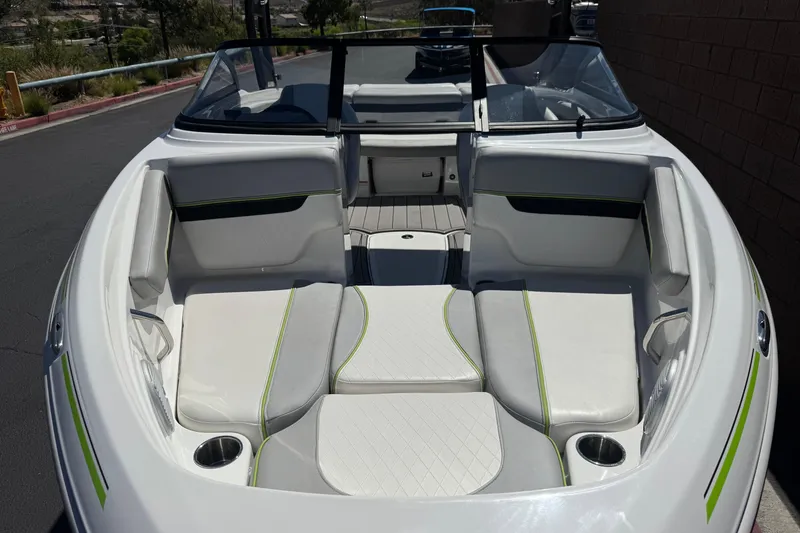 Slide: The Image of 2022 Tahoe 210 Si Limited boat interior with white and green seating. - 9
