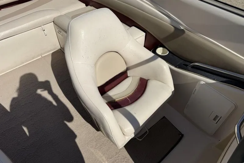 Slide: The Image of 1999 Glastron GT 225 boat interior with white and maroon seating. - 12