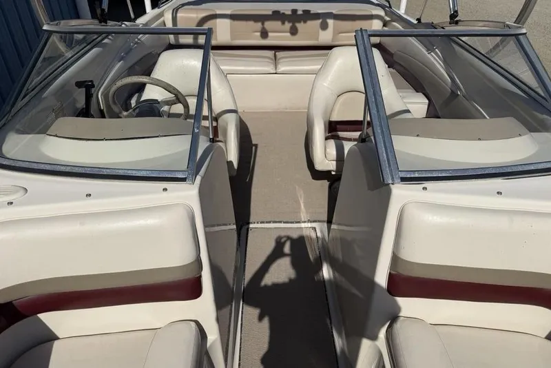 Slide: The Image of 1999 Glastron GT 225 boat interior with dual windshields and seating. - 14