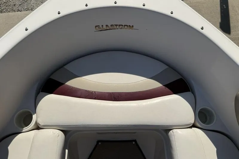 Slide: The Image of 1999 Glastron GT 225 boat interior with white and maroon seating. - 19