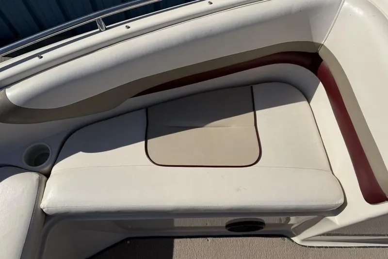Slide: The Image of 1999 Glastron GT 225 boat interior seating with beige and maroon upholstery. - 22
