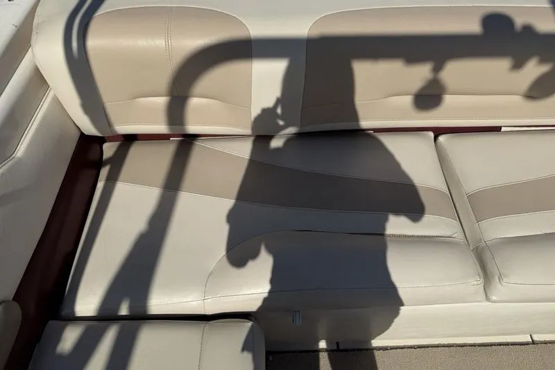 Slide: The Image of Beige leather seating on a 1999 Glastron GT 225 boat with shadow overlay. - 24