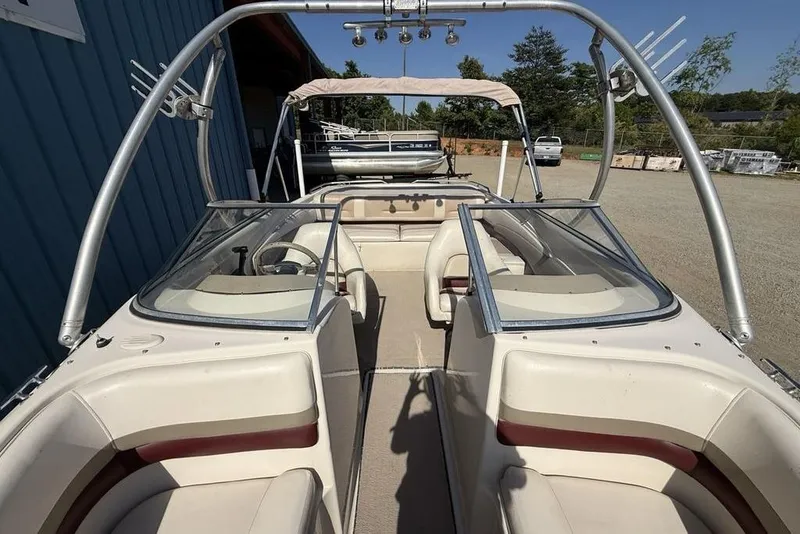 Slide: The Image of 1999 Glastron GT 225 boat with dual windshields and seating, parked outdoors. - 25