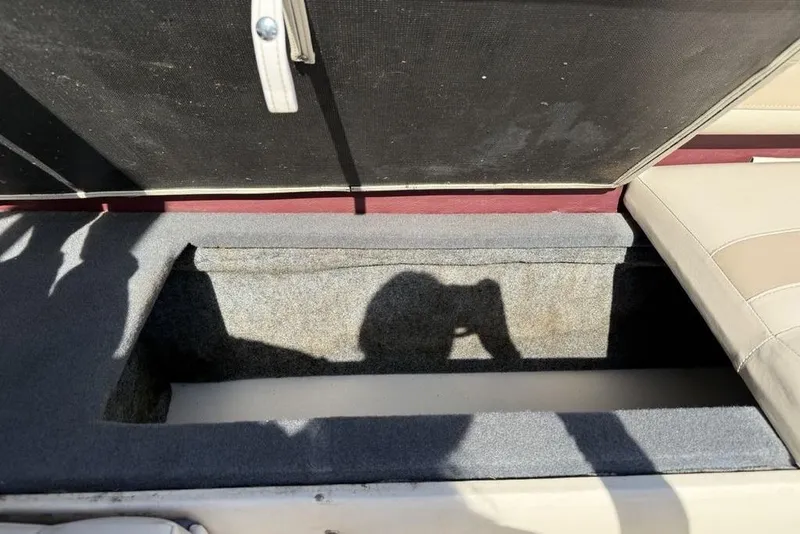 Slide: The Image of Open storage compartment in a 1999 Glastron GT 225 boat interior. - 27