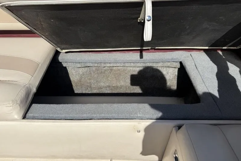 Slide: The Image of Open storage compartment in a 1999 Glastron GT 225 boat interior. - 31