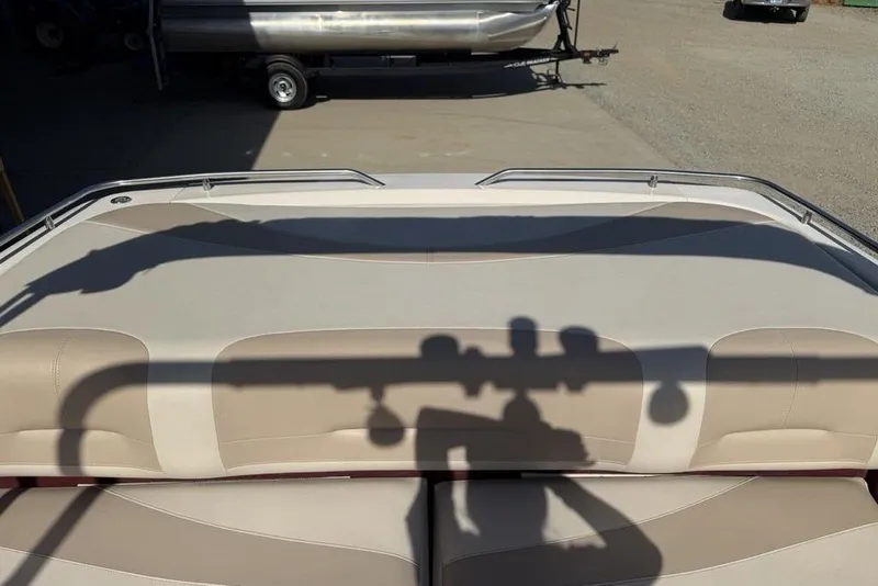 Slide: The Image of 1999 Glastron GT 225 boat interior with beige seating and shadow on upholstery. - 34