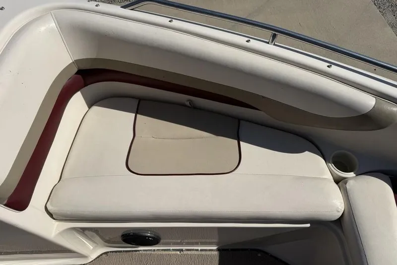 Slide: The Image of Interior seating of a 1999 Glastron GT 225 boat with beige upholstery. - 8