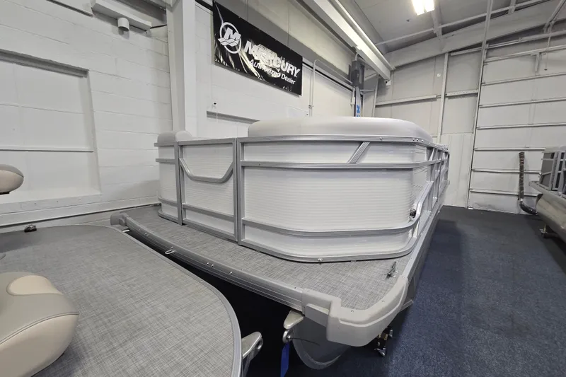 Slide: The Image of 2026 Princecraft Vectra 21 QL pontoon boat displayed indoors, showcasing sleek design. - 2