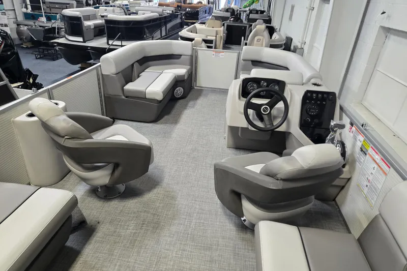 Slide: The Image of 2026 Princecraft Vectra 21 QL pontoon boat interior with plush seating and modern helm. - 3