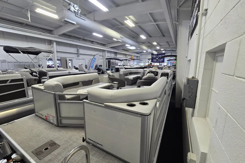 Slide: The Image of 2026 Princecraft Vectra 21 QL pontoon boat displayed in a showroom. - 4