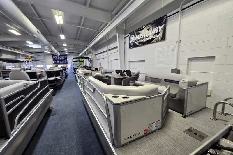 Slide: The Image of 2026 Princecraft Vectra 21 QL pontoon boat displayed in a showroom. - 9